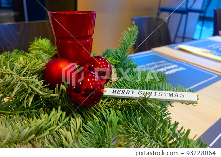 Green spruce branch and candlestick with the inscription Merry Christmas and Happy New Year. 93228064