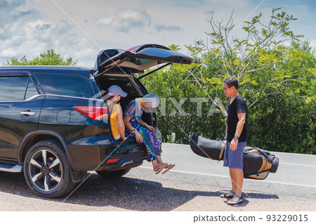 Three best friends enjoying traveling in the car on a road trip. 93229015