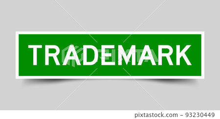 Green color square shape sticker label with word trademark on gray background Green color square shape sticker label with word trademark on gray background 93230449