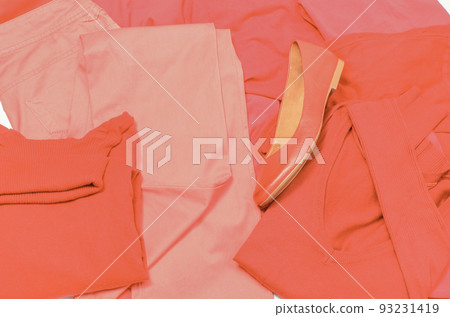 Womanly leather shoes and stack of red clothes 93231419
