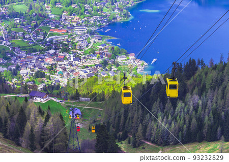 View of St.Gilgen village, Wolfgangsee lake and colorful Seilbahn cable car gondolas from Zwolferhorn mountain in Salzkammergut region, Austria 93232829