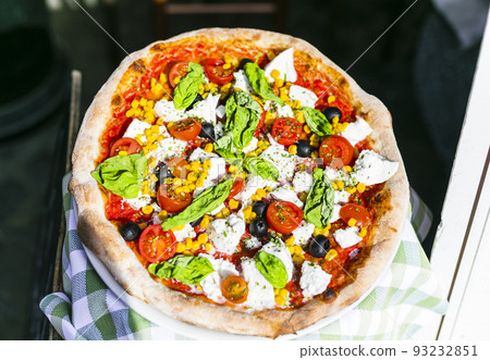 Travel Italy, Part of Italian culture - healthy mediterranean food. Rome street restaurants and pizzeria. Fresh pizza with mozarella ,basilic and tomatos 93232851