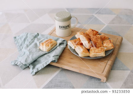freshly baked homemade pastry on kitchen table. breakfast with puff buns and a glass of milk freshly baked homemade pastry on kitchen table. breakfast with puff buns and a glass of milk 93233850