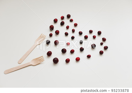 wooden bamboo cutlery and berries on white background, zero waste, no plastic, eco-friendly concept 93233878