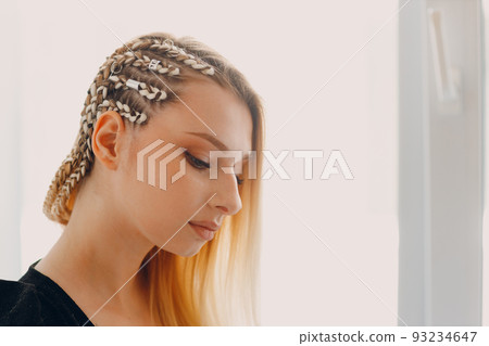 Portrait braided afro braids dreadlocks kanekalon pigtails hair of female client in barber salon. Portrait braided afro braids dreadlocks kanekalon pigtails hair of female client in barber salon. 93234647