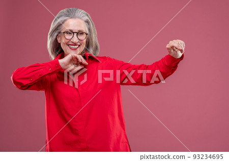 Woman in red shirt moving and smiling Woman in red shirt moving and smiling 93234695