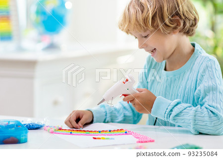 Crafts for kids. Child with hot glue gun. Crafts for kids. Child with hot glue gun. 93235084