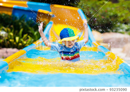 Kids on water slide in aqua park. Summer vacation 93235090