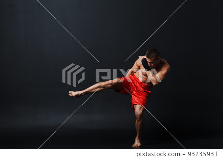 Sportsman muay thai man boxer stance at black background. 93235931