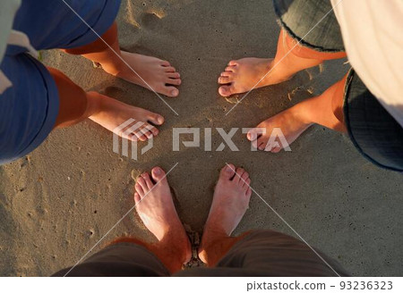 Close-up of the feet of family on the white sandy beach Close-up of the feet of family on the white sandy beach 93236323