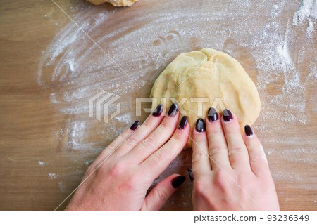 Homemade bread baking. Closeup woman hands kneading The Dough. Beautiful, cook. Dough for pizza or bread. Homemade bread baking. Closeup woman hands kneading The Dough. Beautiful, cook. Dough for pizza or bread. 93236349