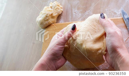 Homemade bread baking. Closeup woman hands kneading The Dough. Beautiful, cook. Dough for pizza or bread. Homemade bread baking. Closeup woman hands kneading The Dough. Beautiful, cook. Dough for pizza or bread. 93236350