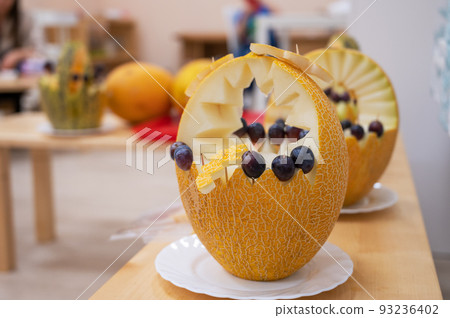 Female hands cutting pumpkin to halloween 93236402