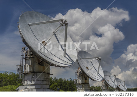 A group of millimeter-wave interferometer antennas against a blue sky with clouds. Image of space, observation, unknown, future, hope 93237316