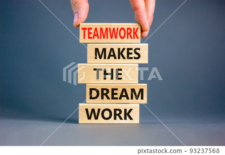 Teamwork makes dream work symbol. Concept words Teamwork makes the dream work on wooden blocks on a beautiful grey background. Businessman hand. Business Teamwork makes dream work concept. Copy space. Teamwork makes dream work symbol. Concept words Teamwork makes the dream work on wooden blocks on a beautiful grey background. Businessman hand. Business Teamwork makes dream work concept. Copy space. 93237568