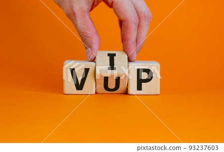 Hand turns a cube and changes the acronym 'VUP' - very unimportant person to 'VIP' - very important person. Beautiful orange background. Business concept. Copy space. Hand turns a cube and changes the acronym 'VUP' - very unimportant person to 'VIP' - very important person. Beautiful orange background. Business concept. Copy space. 93237603