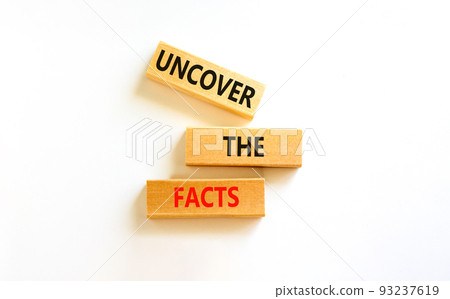 Uncover the facts symbol. Concept words Uncover the facts on wooden blocks on a beautiful white table white background. Business and uncover the facts concept. Copy space. 93237619