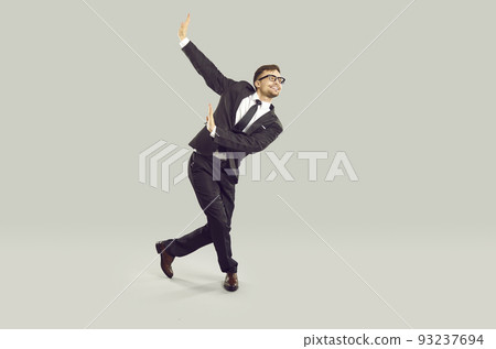 Full length studio shot of happy businessman or office worker dancing and having fun 93237694