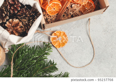 Zero waste and eco friendly christmas concept. Natural decorations and branches of a Christmas tree on the table, top view 93237708