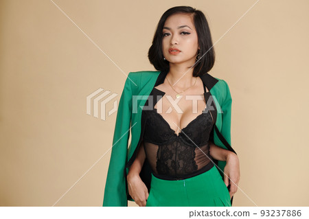 Portrait of sensual young woman wearing lace corset under jacket Portrait of sensual young woman wearing lace corset under jacket 93237886