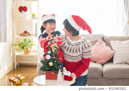 Parents and children exchanging family Christmas gifts 93240582