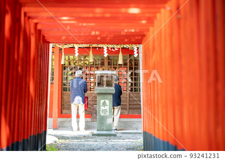 A visitor to Jinkoku Inari Shrine at Kuwana Castle Ruins in Kuwana City, Mie Prefecture 93241231