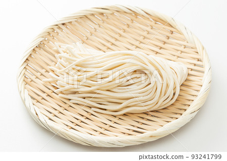 Udon in a colander, raw noodles, white background 93241799