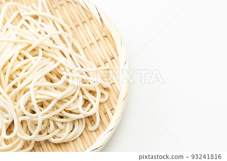 Udon in a colander, raw noodles, white background Udon in a colander, raw noodles, white background 93241816