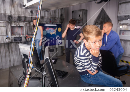 Interested tween boy solving conundrums in escape room 93243004