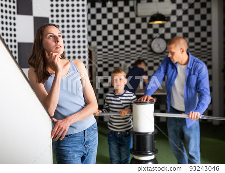 Thoughtful young woman solving conundrums in quest room Thoughtful young woman solving conundrums in quest room 93243046