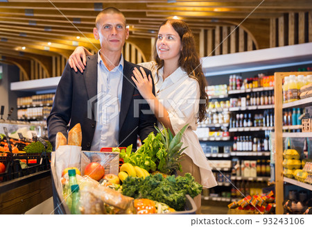 Portrait of a happy young man and girl in a supermarket Portrait of a happy young man and girl in a supermarket 93243106