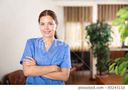 Woman doctor wear white medical uniform and stethoscope look at camera posing in clinic Woman doctor wear white medical uniform and stethoscope look at camera posing in clinic 93243110