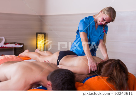 Portrait of young female who is doing relaxation massage to her clients 93243611