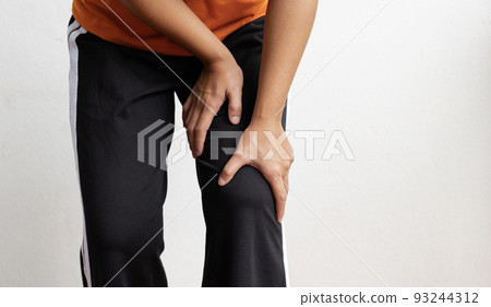 Woman hand massage physiotherapy her knee is sore and numb, exhausted, tingling. Guillain-Barre Syndrome, a side effect of the Covid vaccination Woman hand massage physiotherapy her knee is sore and numb, exhausted, tingling. Guillain-Barre Syndrome, a side effect of the Covid vaccination 93244312