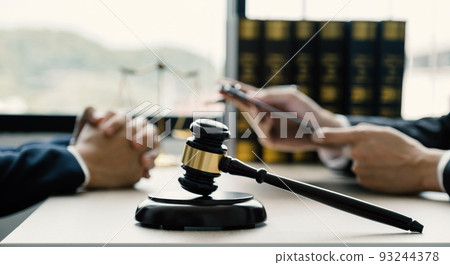 Lawyer hand holding pen and providing legal consult business dispute service to the man at the office 93244378