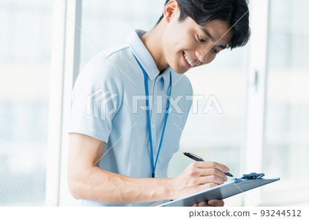 Male caregiver taking notes Male caregiver taking notes 93244512