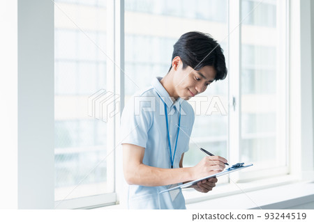 Male caregiver taking notes 93244519