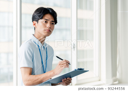 Male caregiver taking notes Male caregiver taking notes 93244556