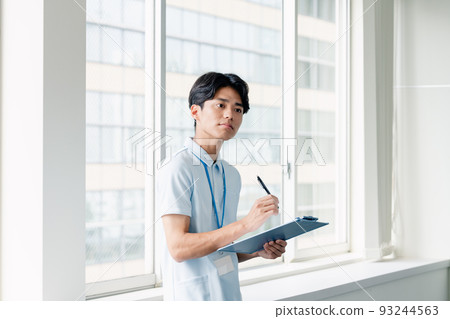 Male caregiver taking notes Male caregiver taking notes 93244563
