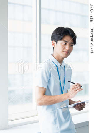 Male caregiver taking notes Male caregiver taking notes 93244577