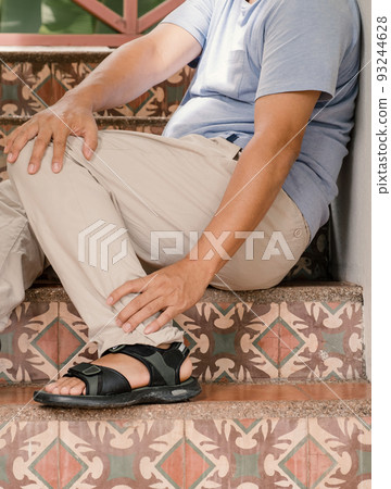 Man hand massage physiotherapy leg is sore and numb, exhausted, tingling. 93244628