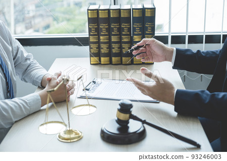 Lawyer hand holding pen and providing legal consult business dispute to the man Lawyer hand holding pen and providing legal consult business dispute to the man 93246003