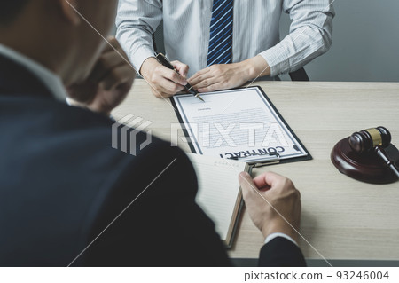 Businessman hand sign after Lawyer providing legal consult dispute service at the office with justice scale and gavel hammer 93246004