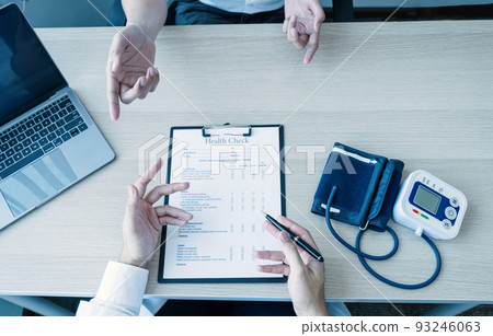 The doctor hand write report and explained the health examination results to the patient, medical checkup concept. The doctor hand write report and explained the health examination results to the patient, medical checkup concept. 93246063