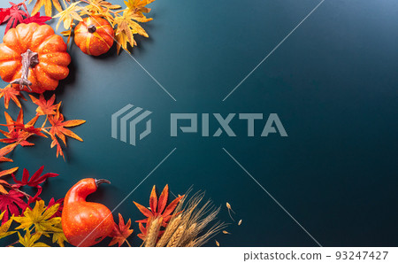 Autumn and thanksgiving decoration concept made from autumn leaves and pumpkin on dark background. Flat lay, top view with copy space. Autumn and thanksgiving decoration concept made from autumn leaves and pumpkin on dark background. Flat lay, top view with copy space. 93247427