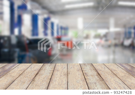 Wood table top with blur garage background Wood table top with blur garage background 93247428