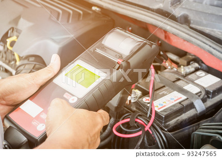 mechanic use voltmeter checking voltage of car battery in car service centre mechanic use voltmeter checking voltage of car battery in car service centre 93247565