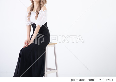 A woman sitting on a chair A woman sitting on a chair 93247603