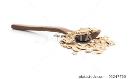 Whole grain cereal flakes in wooden spoon. Wholegrain breakfast cereals isolated on white background. Whole grain cereal flakes in wooden spoon. Wholegrain breakfast cereals isolated on white background. 93247760