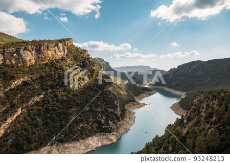 Beautiful landscape of forest woods and calm tranquil lake. Fat white clouds on blue sky in aerial drone shot. 93248213